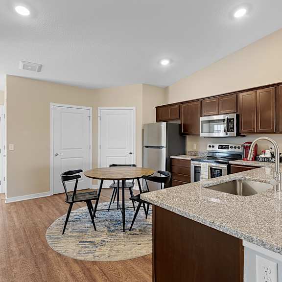 a kitchen with a table and chairs in the middle of the room.