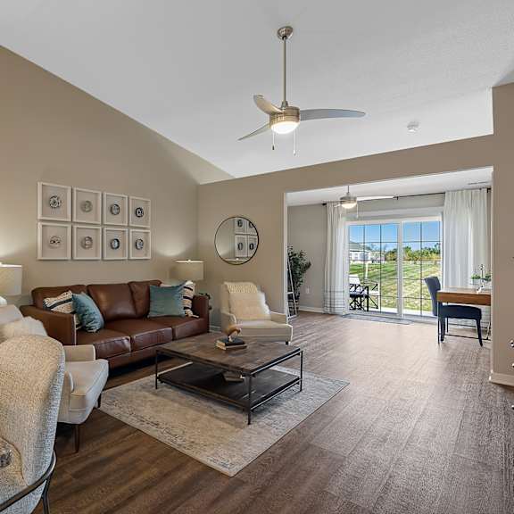 a living room with a grey counter top and a brown couch.
