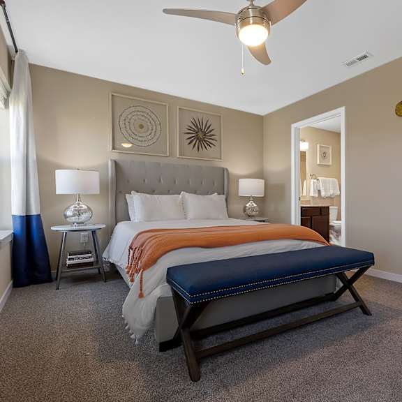 a bedroom with a large bed and a ceiling fan.