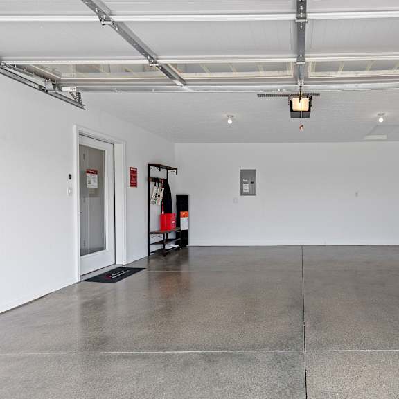 a white room with a concrete floor and a poster on the wall.