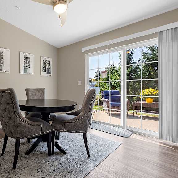 a dining room with a table and chairs.