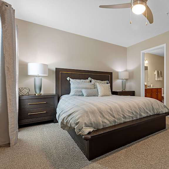 a bedroom with a large bed and a ceiling fan.