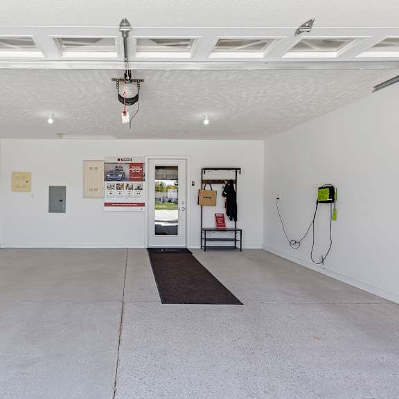 a white room with a black mat on the floor.