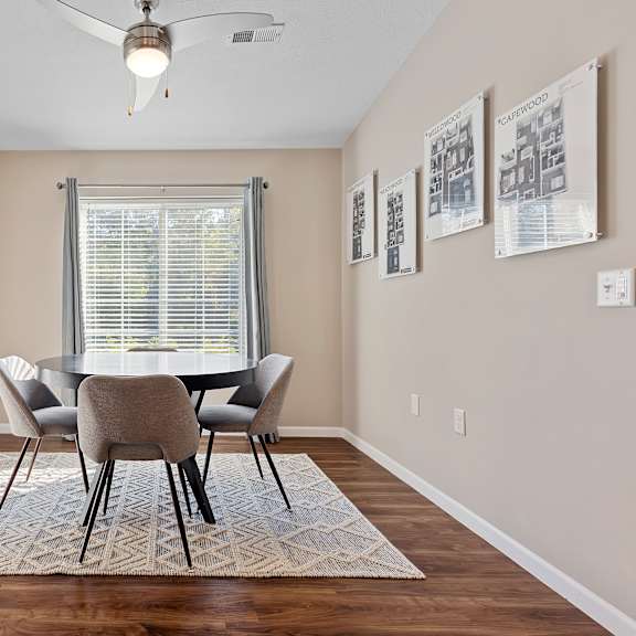 a dining room with a table and chairs.