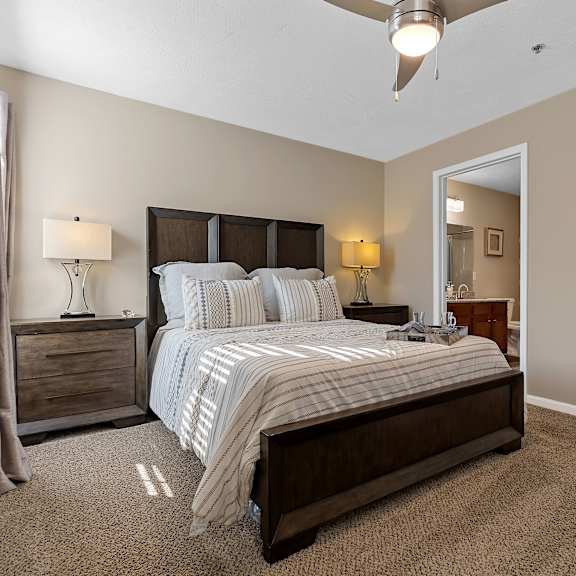 a bedroom with a large bed and a ceiling fan.