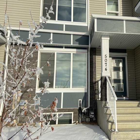 a house numbered 503 is shown with snow on the ground and a tree in front.