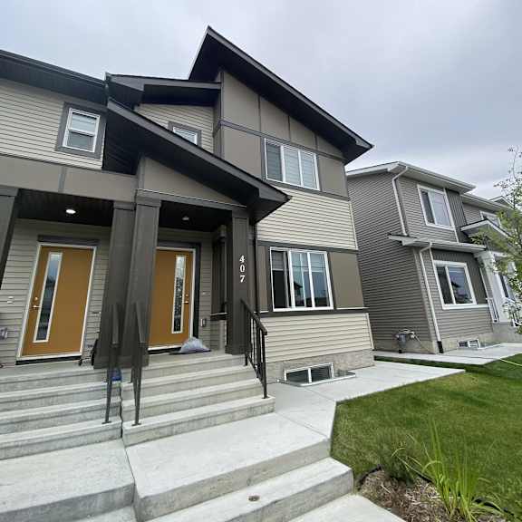 a modern house with a brown door and a grey facade.