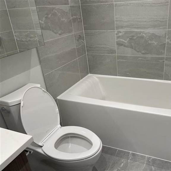 a bathroom with a toilet and a bath tub