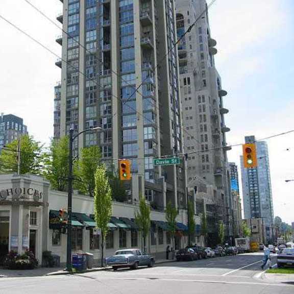 a city street with a tall building in the background