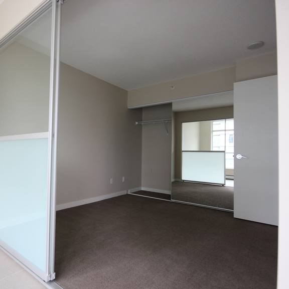 an empty living room with a sliding glass door
