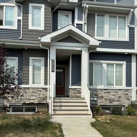 a house with a grey front and a brown door.