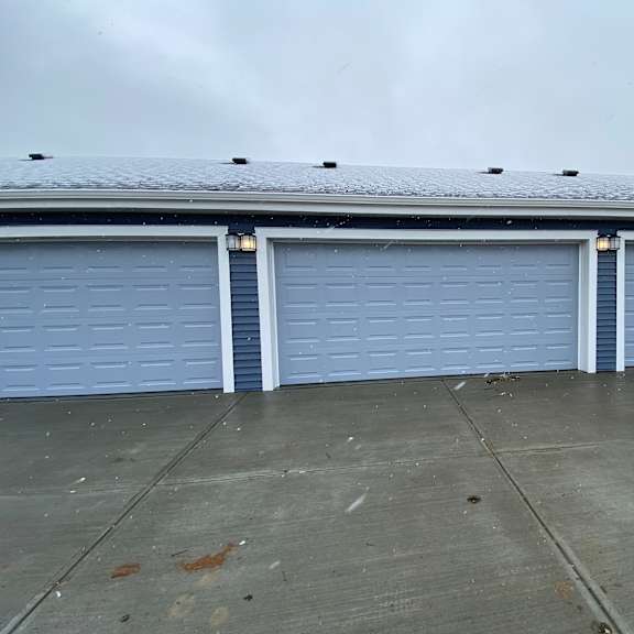 a building with three garage doors.