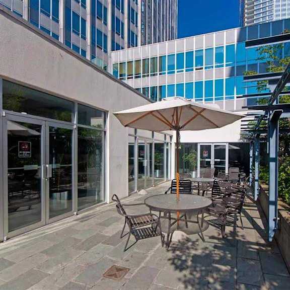 a patio with a table and chairs under an umbrella.
