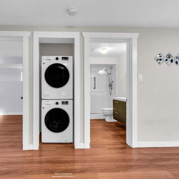 a white washer and dryer in a laundry room.