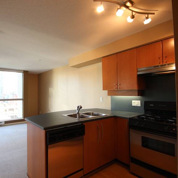 a kitchen with a stove top oven next to a window
