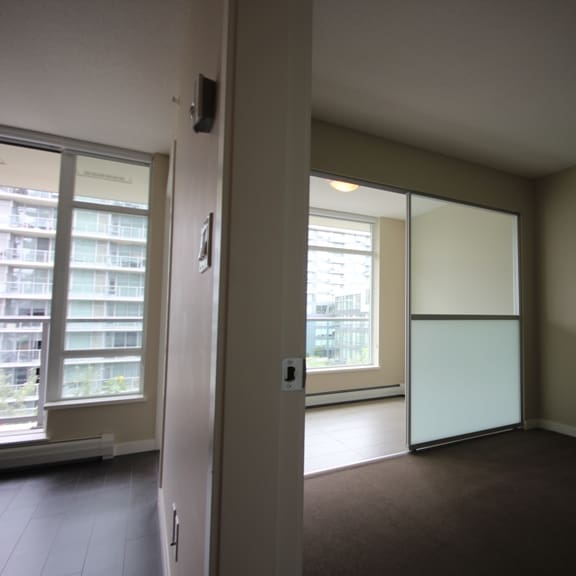 an empty living room with a sliding glass door