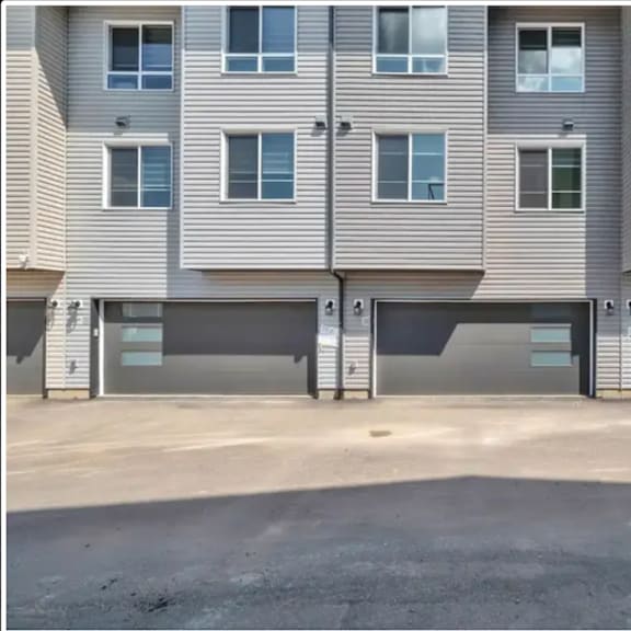 an empty parking lot in front of an apartment building