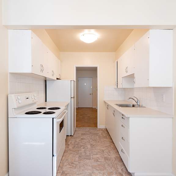 a kitchen with white appliances and white cabinets