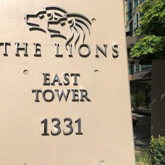 a sign for the lions east tower 1331 with a lion graphic above the text.