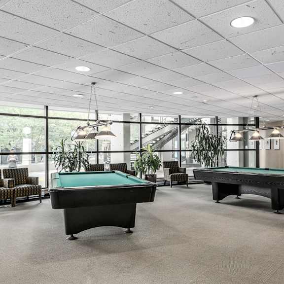 a room with a pool table and a billiard table.