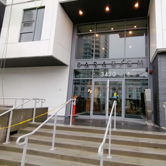 the entrance of a building with stairs in front of it