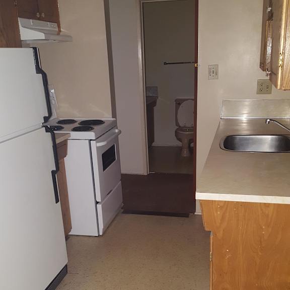 a kitchen with a sink and a refrigerator