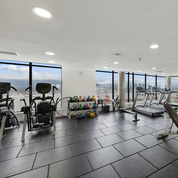 a gym with a view of the city.