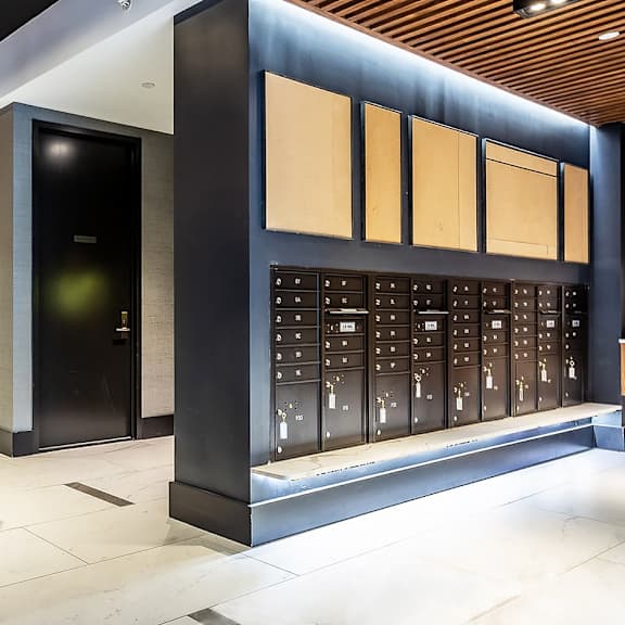 a modern lobby with a black and gold circular light fixture.