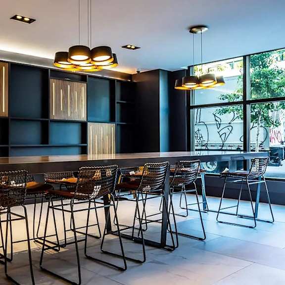 a modern dining room with a long table and chairs.