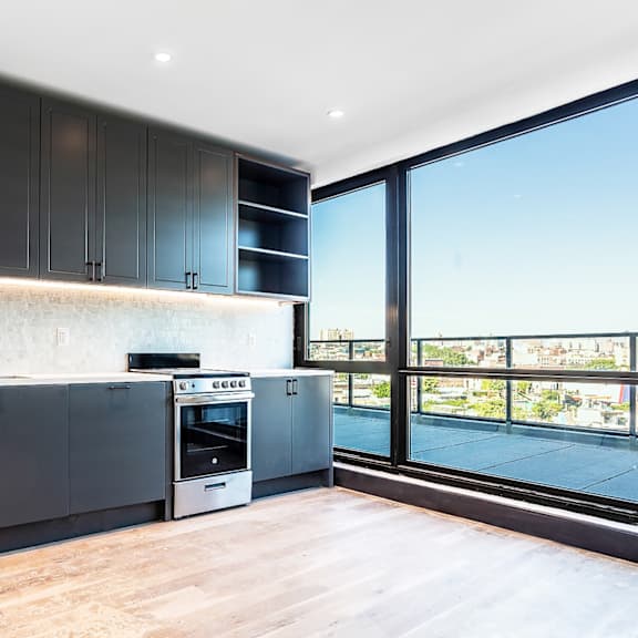 a modern kitchen with dark wood cabinets and stainless steel appliances.
