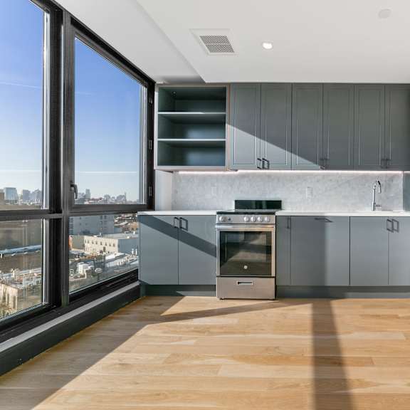 a modern kitchen with a view of the city.