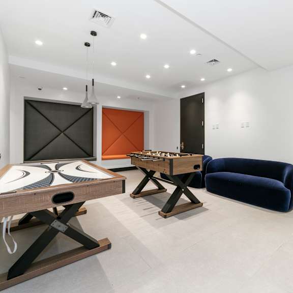 a room with a table, chairs, and a couch.