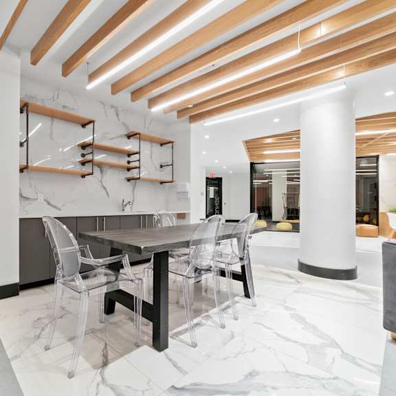 a modern dining area with a table and chairs.