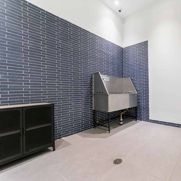 a room with a blue brick wall and a yellow chair.