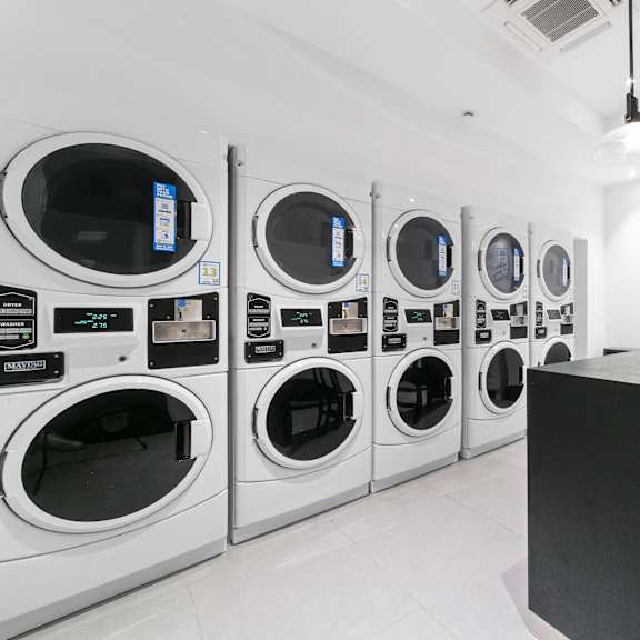a row of washing machines in a laundromat.