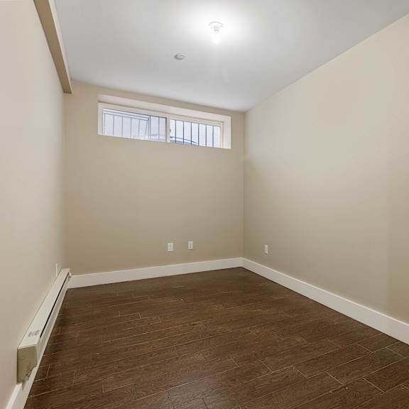 a room with wooden floors and a window.