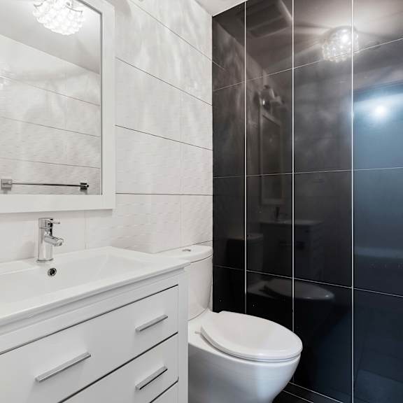 a white sink and toilet in a bathroom.