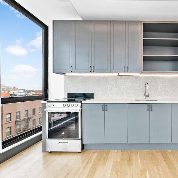 a kitchen with a view of the city outside the window.