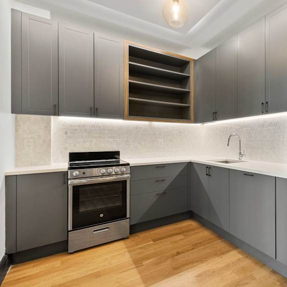 a modern kitchen with a stainless steel refrigerator and a built-in oven.