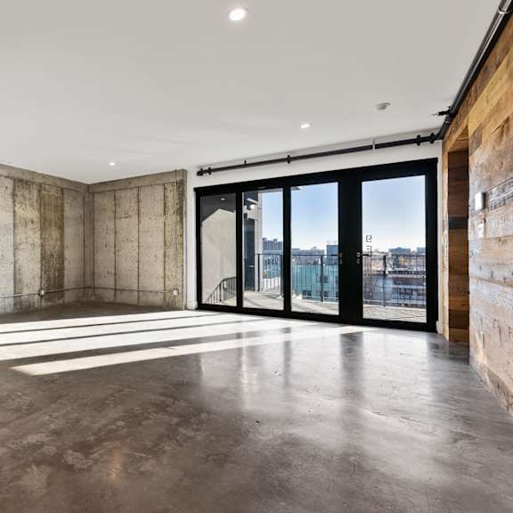 a large empty room with concrete walls and floors.