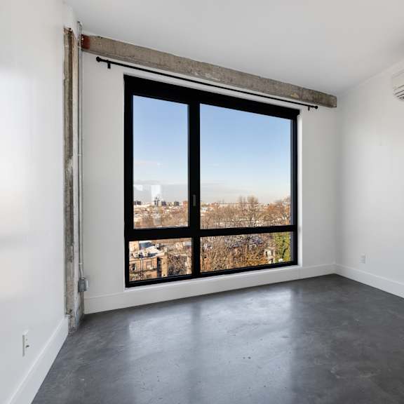 a room with a large window and a sliding door.