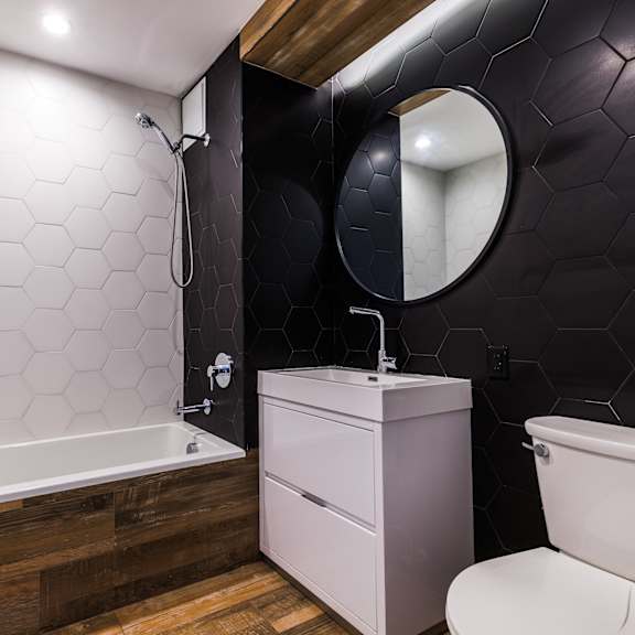 a white toilet sits next to a sink in a bathroom.