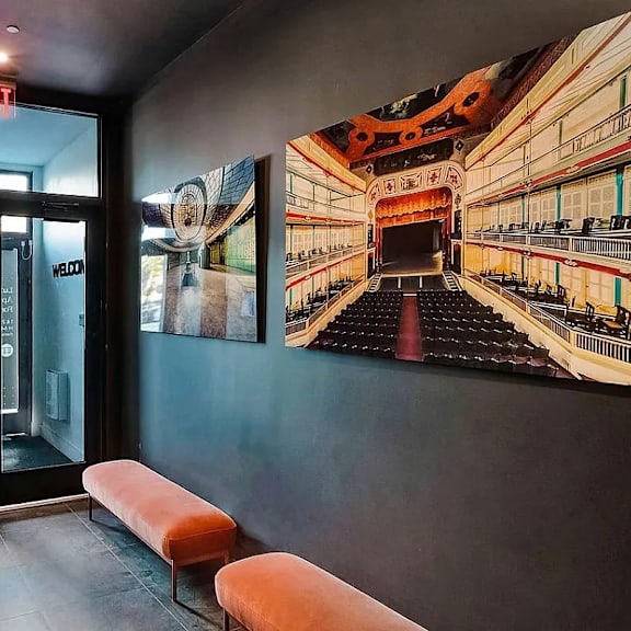 a theater with a stage and a painting of a theater on the wall.