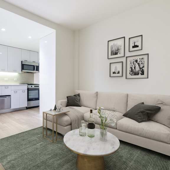 a modern living room with a kitchen in the background.