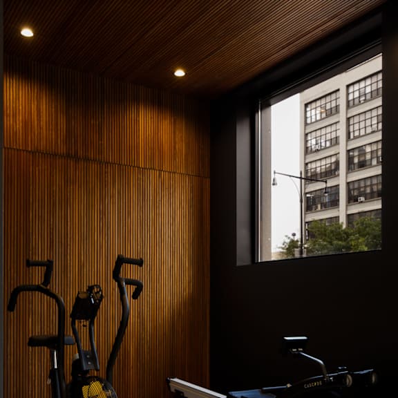 a gym with exercise equipment and a large window