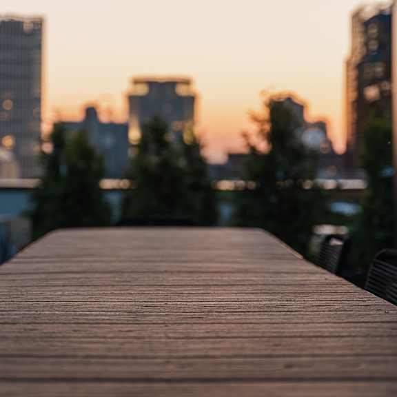 a wooden dock with a city in the background