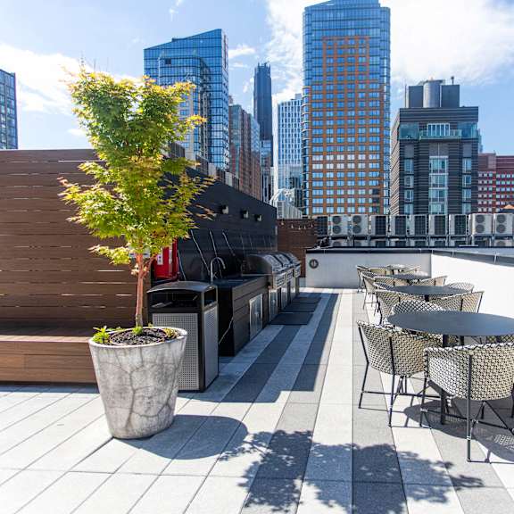 rooftop deck with outdoor kitchen and city views at 260 gold apartments, new york, 11201
