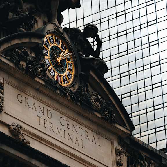 a clock is mounted above the entrance to grand central terminal.