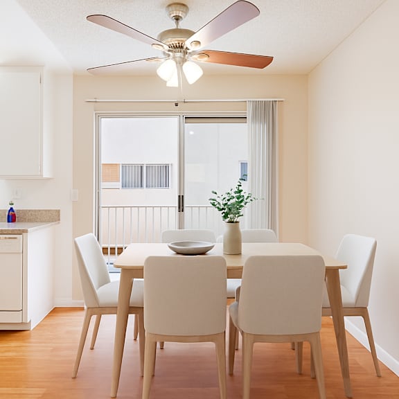 a dining room with a table set for four.