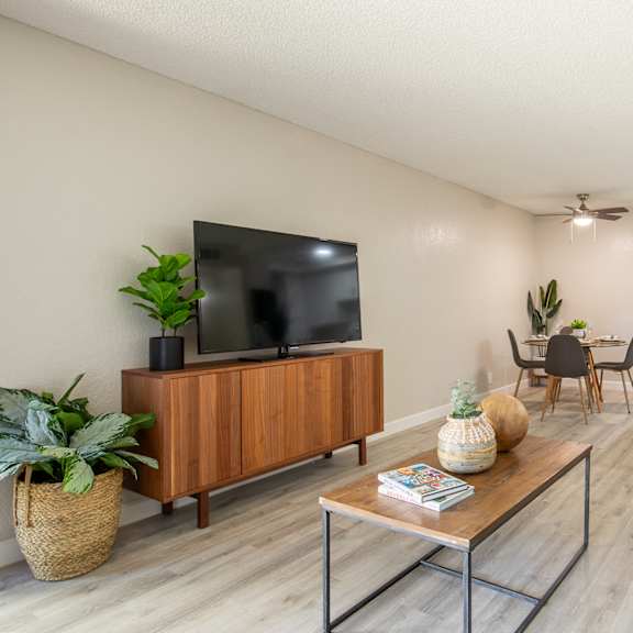 living room with a tv and dining room in the background at banbury apartments riverside